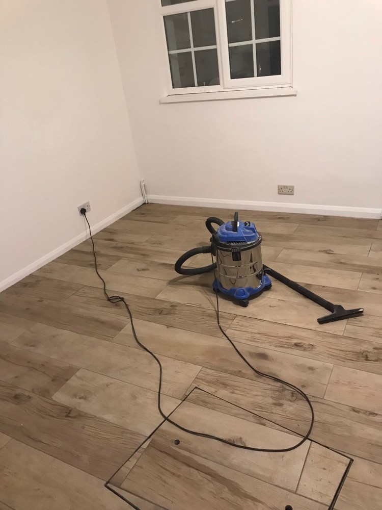 Newly laid wood-effect tiled floor in a renovated room